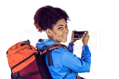 Portrait of a young woman with backpack looking back