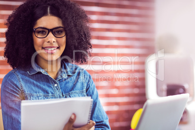 Casual businesswoman holding reports