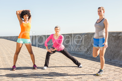 Sporty women stretching together