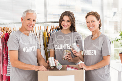 Smiling volunteers sorting donations