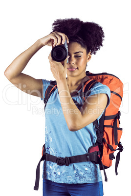 Young woman with backpack taking picture