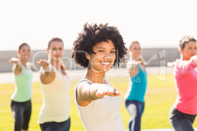 Smiling sporty woman doing yoga in yoga class