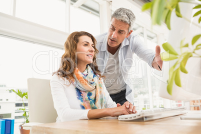 Casual designer briefing his colleague