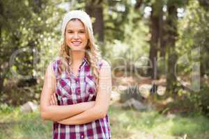 Pretty young blonde smiling with arms crossed