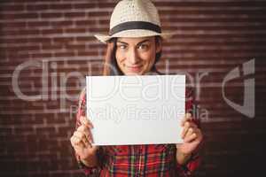 Beautiful hipster showing white card