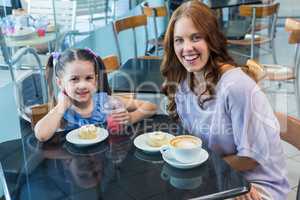 Mother and daughter enjoying cakes