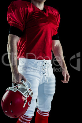 American football player holding his helmet