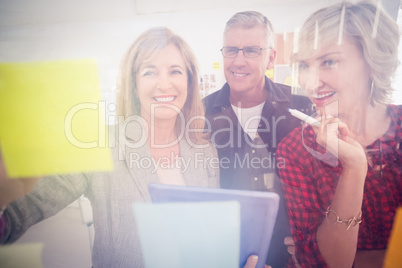 Smiling business team working on tablet