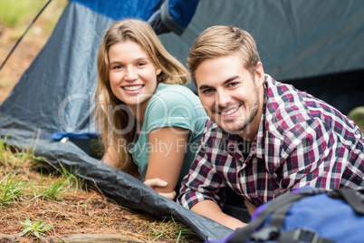 Portrait of a young happy couple lying in a tent Portrait of a young happy couple lying in a tent