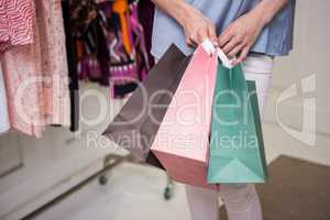 Woman standing with shopping bags