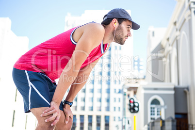 Exhausted athlete leaning forward after an effort