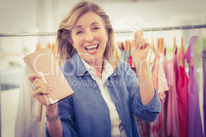 Cheering woman going shopping and showing wallet