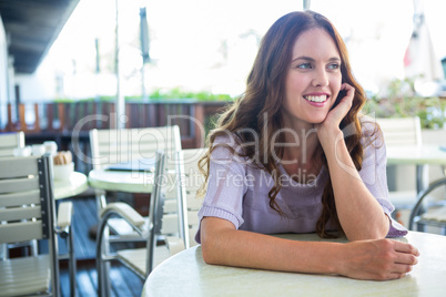 Pretty woman sitting outside at cafe
