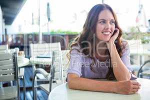 Pretty woman sitting outside at cafe