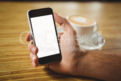 Man using her smartphone with coffee