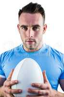 Rugby player looking at camera with ball