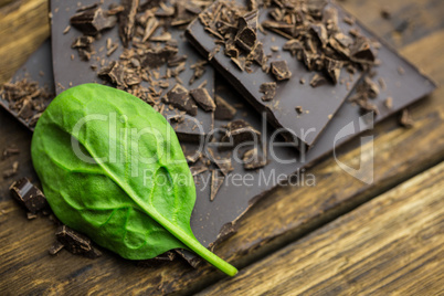 Chocolate with basilica on a wooden table