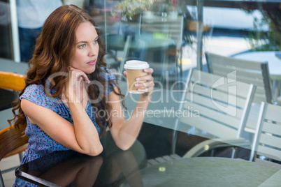 Pretty brunette with take away cup