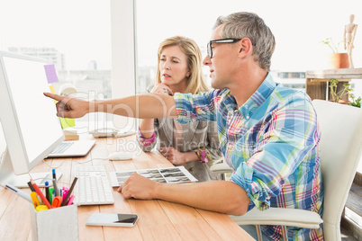 Creative design team working together on computer