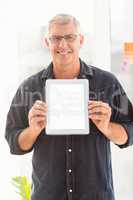 Smiling businessman showing a digital tablet