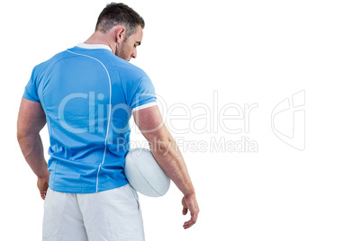 Rugby player standing with ball