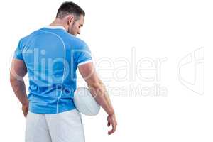 Rugby player standing with ball