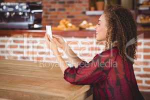 Smiling woman using smartphone