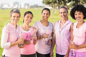 Smiling women wearing pink for breast cancer