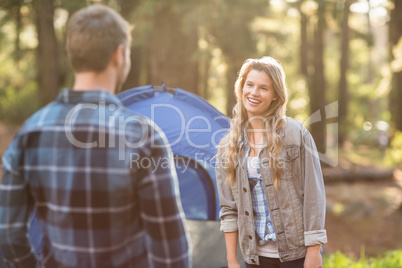 Happy young camper couple looking at each other