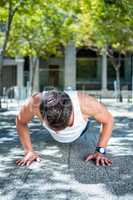 Handsome athlete doing push ups