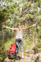 Carefree blonde hiker with arms outstretched