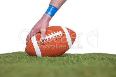 American football player placing the ball