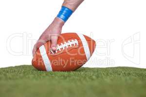 American football player placing the ball