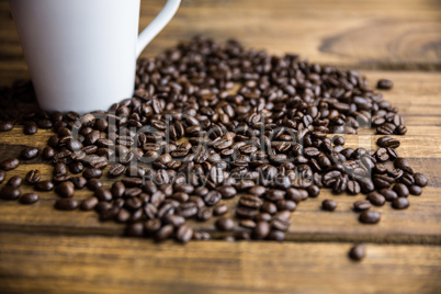 Coffee beans on a table with cup