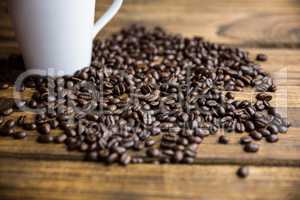 Coffee beans on a table with cup