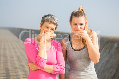Sporty mother and daughter laughing
