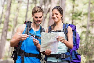 Happy hikers looking at map