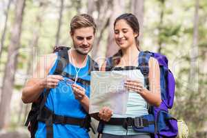 Happy hikers looking at map