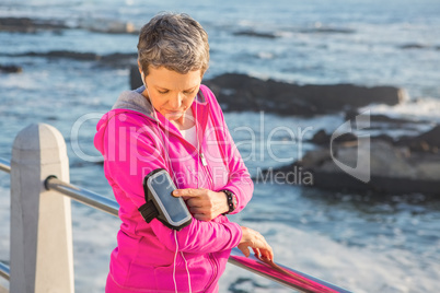 Sporty woman listening to music via headphones