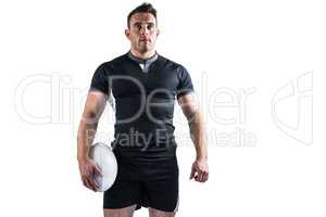 Tough rugby player holding ball