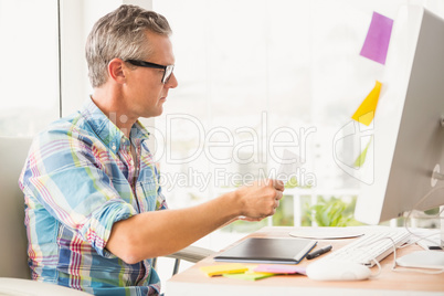 Casual designer working at his desk