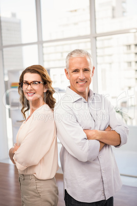 Smiling casual business colleagues with arms crossed