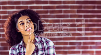 Attractive young woman smiling and daydreaming