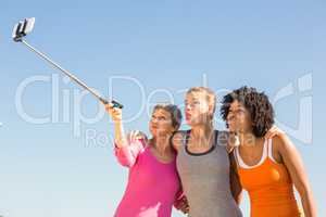 Sporty women posing and taking selfies with selfiestick