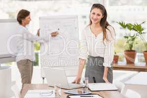 Smiling businesswoman preparing meeting