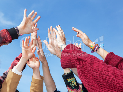 Many hands stretch in the height