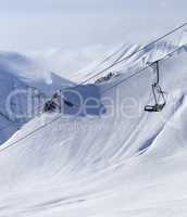 Chair lift at ski resort and off piste slope