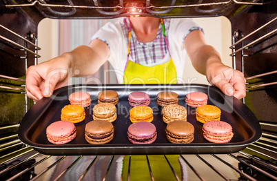 Baking macarons in the oven.