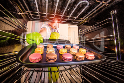 Baking macarons in the oven.