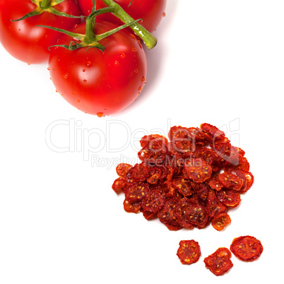 Ripe tomato with water drops and dried slices of tomato